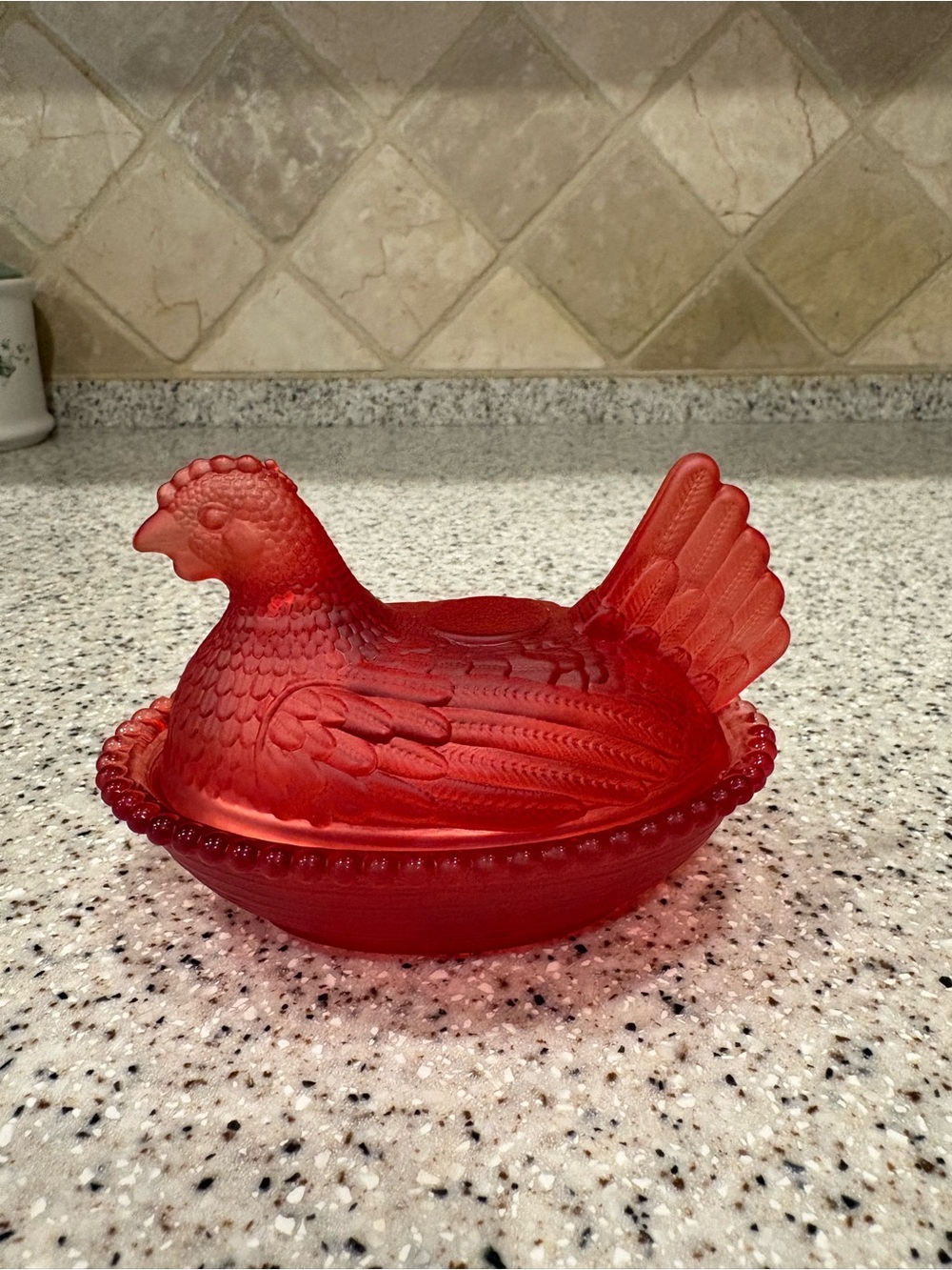 Ruby red frosted glass hen on a nest